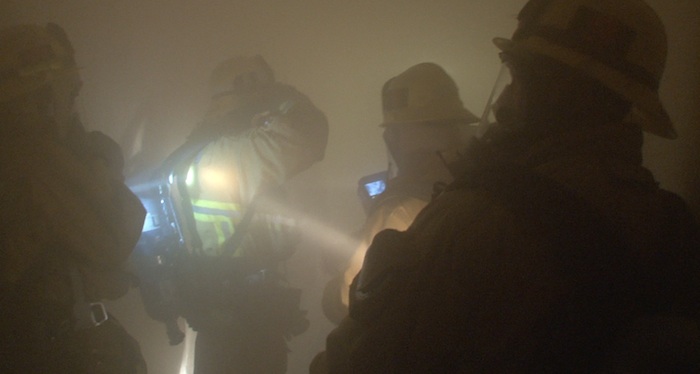irefighters assemble in a smoke-filled corridor