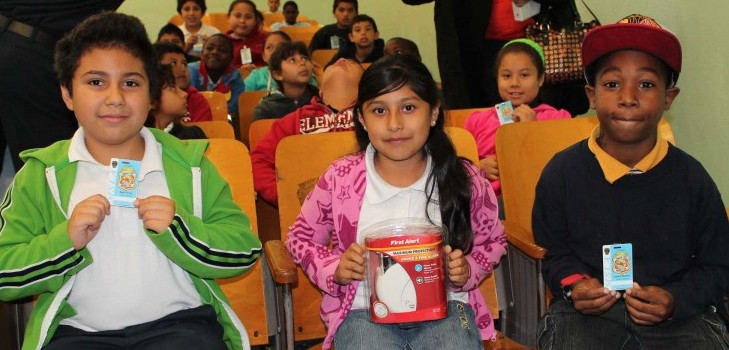 kids holding Jr. Fire Inspector badges