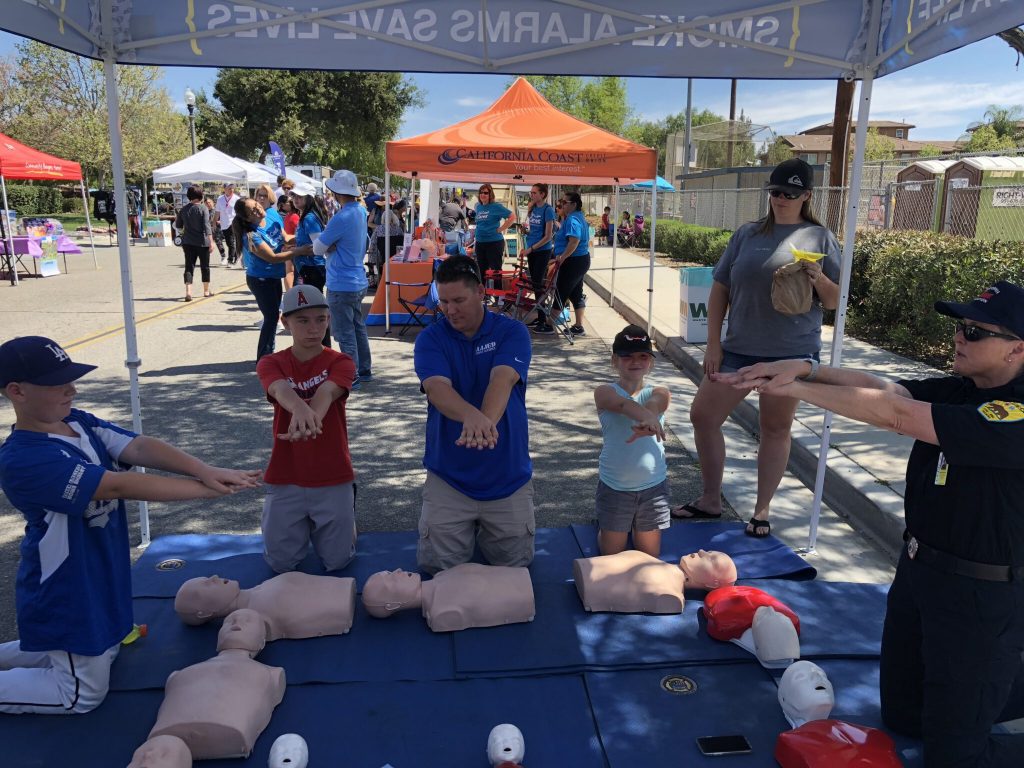 Public Safety Officer MH Cameron-Barrett teaches CPR to a group of people.