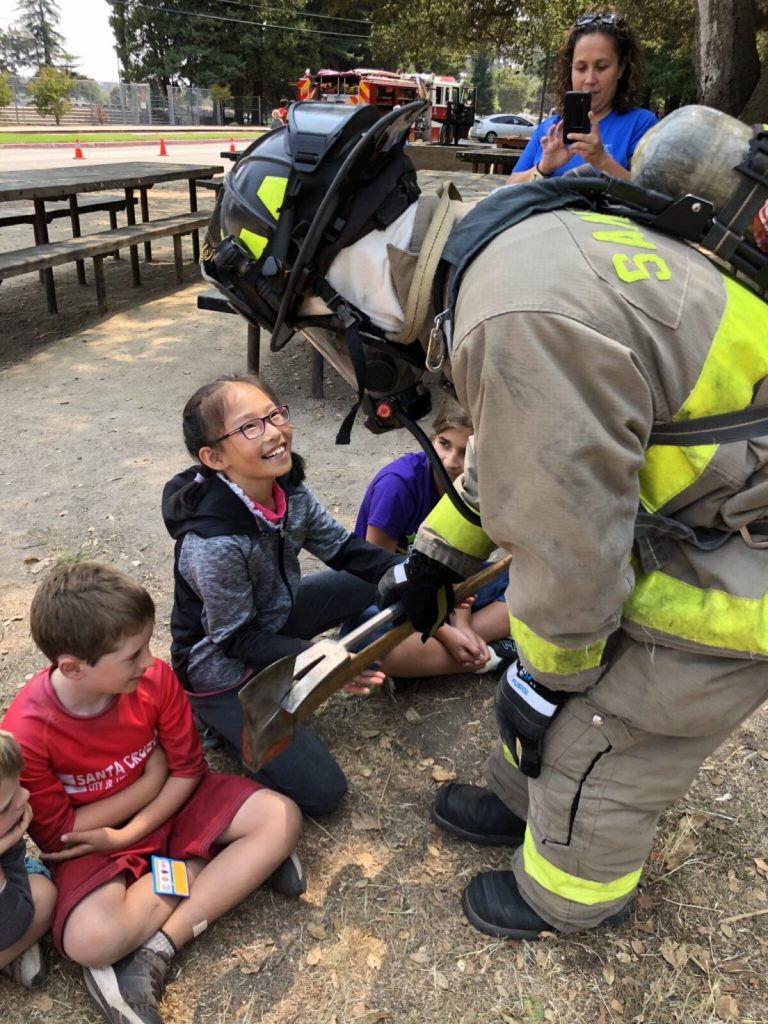 students interact with firefighters as part of the CalFire school program.