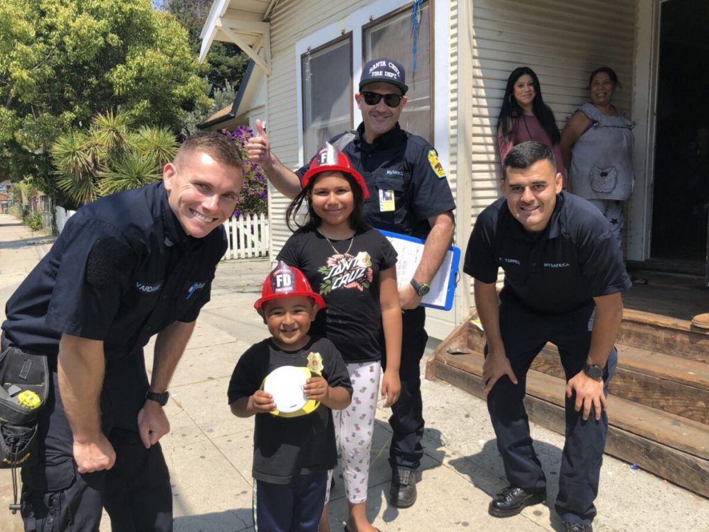 CalFire Prevention officers with a family in Santa Cruz, California